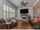 Cozy living room with a brick accent wall, hardwood floors, and comfortable seating at 1404 Lookout Cir, Waxhaw, NC 28173