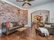 Bright, open living space with hardwood floors and brick accent wall at 1404 Lookout Cir, Waxhaw, NC 28173