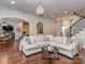 Inviting living room with hardwood floors, a large sectional couch, and stylish decor at 1404 Lookout Cir, Waxhaw, NC 28173