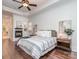 This main bedroom features a fireplace, hardwood floors, and a decorative trey ceiling with soft lighting at 1404 Lookout Cir, Waxhaw, NC 28173