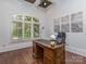 Home office featuring a classic wooden desk, a plush leather chair, and bright natural light at 1404 Lookout Cir, Waxhaw, NC 28173