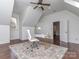 Well-lit office featuring hardwood floors, a desk, and a sloped ceiling at 1404 Lookout Cir, Waxhaw, NC 28173