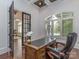 Home office with a traditional wooden desk, and a comfortable leather chair, flooded with natural light at 1404 Lookout Cir, Waxhaw, NC 28173