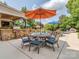 Poolside patio with outdoor seating, dining area, built in outdoor kitchen and lush landscaping at 1404 Lookout Cir, Waxhaw, NC 28173