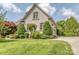 Two-story home featuring an attached garage, well-maintained lawn, and manicured greenery at 1404 Lookout Cir, Waxhaw, NC 28173