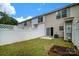 Backyard with well-kept lawn, fence, small garden bed, and sliding glass doors at 15042 Deshler Ct, Charlotte, NC 28273
