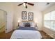 Carpeted bedroom with a ceiling fan, neutral walls, and a bright window view at 15042 Deshler Ct, Charlotte, NC 28273