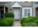 Close-up of an inviting entryway with lush green bushes and a well-lit walkway at 15042 Deshler Ct, Charlotte, NC 28273