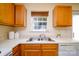Close up on a kitchen sink with double basin and matching wooden cabinetry at 15042 Deshler Ct, Charlotte, NC 28273