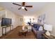 Comfortable living room featuring a ceiling fan, open layout, and warm carpeting at 15042 Deshler Ct, Charlotte, NC 28273