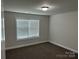 Cozy bedroom with neutral carpet, a window providing natural light, and freshly painted walls at 1521 Park Ave, Salisbury, NC 28146
