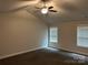 Bedroom featuring plush carpeting, neutral tones, a ceiling fan, and windows at 1521 Park Ave, Salisbury, NC 28146