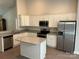 Modern kitchen with stainless steel appliances, granite countertops, white cabinetry, and a convenient center island at 1521 Park Ave, Salisbury, NC 28146