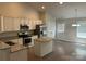 Well-lit kitchen boasts stainless steel appliances, ample white cabinetry, granite counters, and an island with bar seating at 1521 Park Ave, Salisbury, NC 28146
