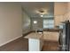 Bright kitchen featuring granite countertops, stainless steel appliances, white cabinets, and a functional island at 1521 Park Ave, Salisbury, NC 28146