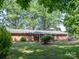 Expansive backyard showing the deck and patio with mature trees and lush landscaping at 160 Eagle Dr, Salisbury, NC 28144