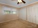 Bedroom features a ceiling fan, closet, and window at 160 Eagle Dr, Salisbury, NC 28144