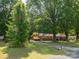 A brick home with a long driveway surrounded by mature trees and a green lawn at 160 Eagle Dr, Salisbury, NC 28144