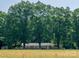 Traditional brick home with a charming facade, nestled among mature trees and a field at 160 Eagle Dr, Salisbury, NC 28144