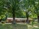 Brick ranch home with a large lawn and mature trees in a quiet neighborhood at 160 Eagle Dr, Salisbury, NC 28144