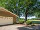 Brick home featuring an attached garage, landscaping, and picturesque view of an open field at 160 Eagle Dr, Salisbury, NC 28144