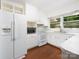 Bright kitchen with white cabinetry, matching appliances, and laminate countertops at 160 Eagle Dr, Salisbury, NC 28144