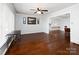 Open-concept living area with hardwood floors, ceiling fan, and seamless flow to dining at 160 Eagle Dr, Salisbury, NC 28144