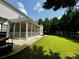 Beautiful backyard featuring a well-maintained lawn and a screened-in porch at 16012 Caranna Ct, Charlotte, NC 28277