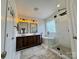 Bathroom featuring double vanity, freestanding tub and walk-in shower with glass enclosure at 16012 Caranna Ct, Charlotte, NC 28277
