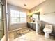 Neutral colored bathroom offers ample vanity counter space and tiled flooring at 16012 Caranna Ct, Charlotte, NC 28277