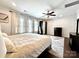 Large bedroom with a ceiling fan, plenty of natural light, a large wardrobe and a dresser at 16012 Caranna Ct, Charlotte, NC 28277