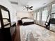 Spacious bedroom with dark wood furniture, neutral walls, and large area rug at 16012 Caranna Ct, Charlotte, NC 28277