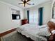 Cozy bedroom featuring a ceiling fan, television and natural light through the window with curtains at 16012 Caranna Ct, Charlotte, NC 28277