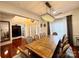 Spacious dining area with hardwood floors, a modern chandelier, and ample seating for entertaining at 16012 Caranna Ct, Charlotte, NC 28277