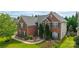 Two-story brick home featuring well-maintained landscaping, dark shutters, and a gray roof at 16012 Caranna Ct, Charlotte, NC 28277