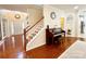 Open-concept foyer showcasing a grand staircase, gleaming hardwood floors, and stylish accents at 16012 Caranna Ct, Charlotte, NC 28277