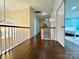 Upstairs hallway with hardwood floors and modern chandelier at 16012 Caranna Ct, Charlotte, NC 28277