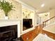 Cozy living room featuring a fireplace, custom stone wall, and modern decor, ideal for relaxing and entertaining at 16012 Caranna Ct, Charlotte, NC 28277