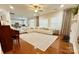 Open-concept living room with a white sofa, fireplace, and hardwood floors, perfect for modern living at 16012 Caranna Ct, Charlotte, NC 28277