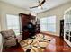 Well-lit home office with a built-in desk, hardwood floors, and a comfortable chair at 16012 Caranna Ct, Charlotte, NC 28277