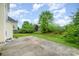 Landscaped backyard with a concrete patio, lush green grass, and mature trees at 170 Glenn Allen Rd, Mooresville, NC 28115