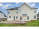 View of the home's backyard, featuring a concrete patio and well-maintained lawn at 170 Glenn Allen Rd, Mooresville, NC 28115