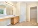 Bright bathroom featuring single sink vanity, large mirror, tile floors, and walk-in shower at 170 Glenn Allen Rd, Mooresville, NC 28115