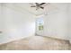 Empty bedroom with neutral walls, bright light, carpet floors and a ceiling fan at 170 Glenn Allen Rd, Mooresville, NC 28115