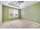 Cozy bedroom features plush carpet, green walls, tray ceiling, and lots of natural light at 170 Glenn Allen Rd, Mooresville, NC 28115