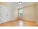 Bright bedroom features wood floors, a window for natural light, and a double door closet at 170 Glenn Allen Rd, Mooresville, NC 28115