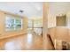 Bright hallway features wood floors, large window, chandelier, and view of stairs at 170 Glenn Allen Rd, Mooresville, NC 28115