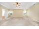 Spacious main bedroom features tray ceiling, ceiling fan, plush carpet, and natural light at 170 Glenn Allen Rd, Mooresville, NC 28115