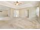 Large main bedroom boasts a tray ceiling, natural light, and multiple entry doors at 170 Glenn Allen Rd, Mooresville, NC 28115