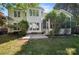 Backyard view of the two story home surrounded by lush greenery at 17101 Windy Oaks Ct, Cornelius, NC 28031